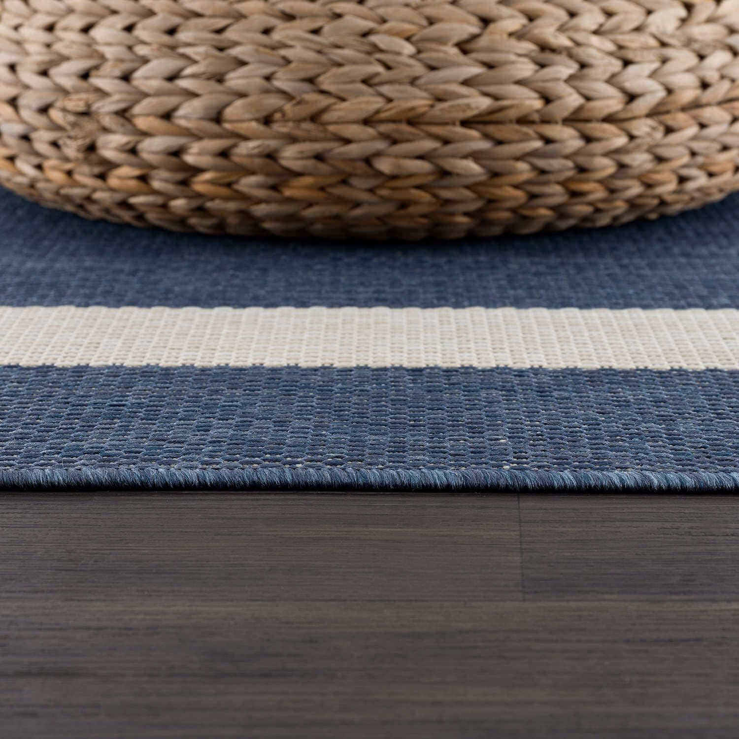 CAMILSON short-pile outdoor rug resists dirt buildup in busy spaces.