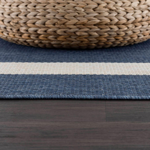 CAMILSON short-pile outdoor rug resists dirt buildup in busy spaces.