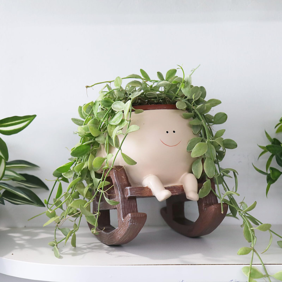 Camotank Smiley-face rocking chair planter brightens gardens and tabletops.