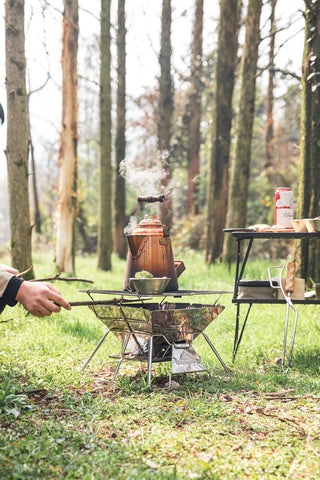 Camping Moon MT-2 dual-function fire pit and grill for versatile outdoor cooking.