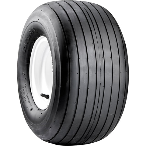 Carlisle Straight Rib Tire mud-and-grass image demonstrating smooth roll on uneven terrain