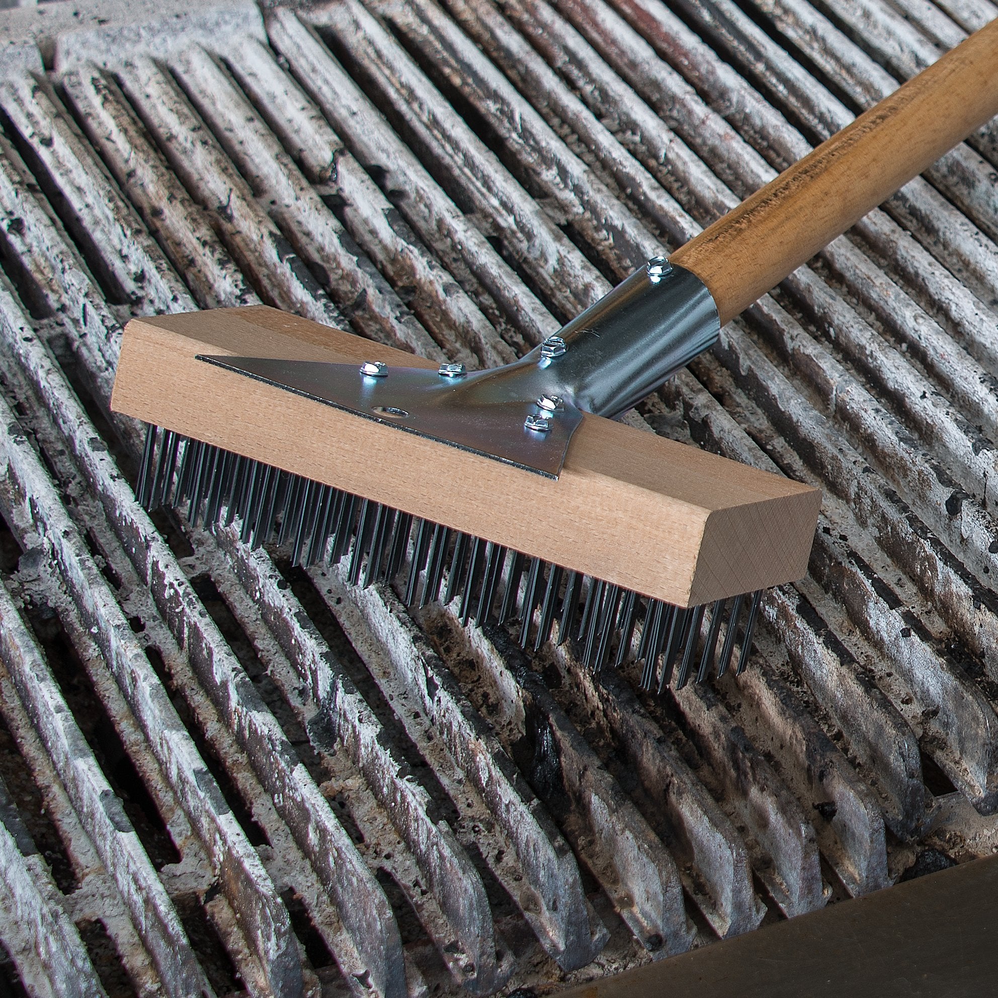 Carlisle Wood Oven Brush on grill helps remove carbon deposits efficiently.