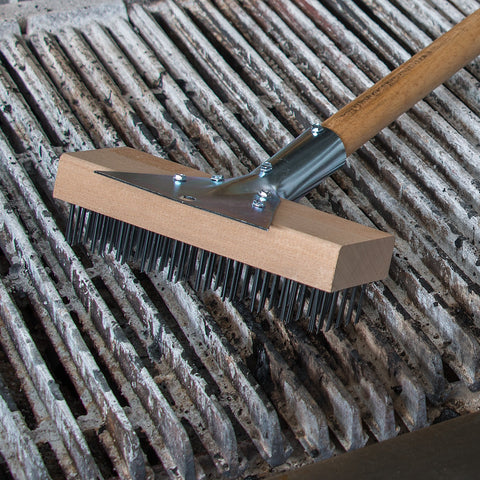 Carlisle Wood Oven Brush on grill helps remove carbon deposits efficiently.