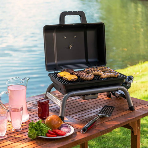 Char-Broil 1-Burner portable grill cooking area filled with burgers and brats.