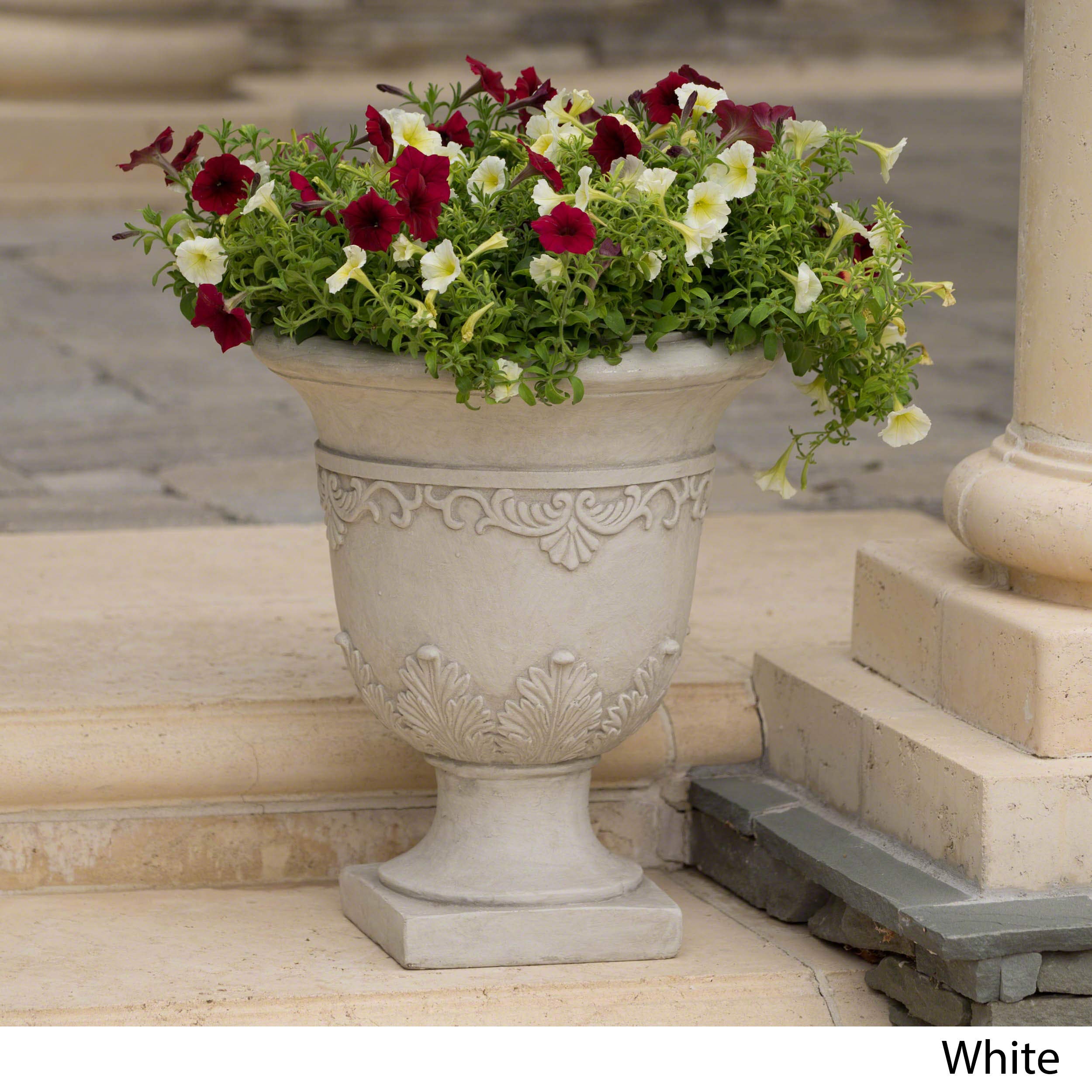 Detailed moulding and antique white finish highlight traditional design.