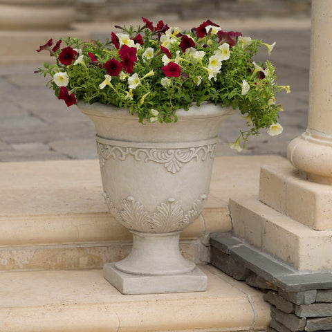 Outdoor patio scene with the 20-inch white urn planter adds curb appeal.
