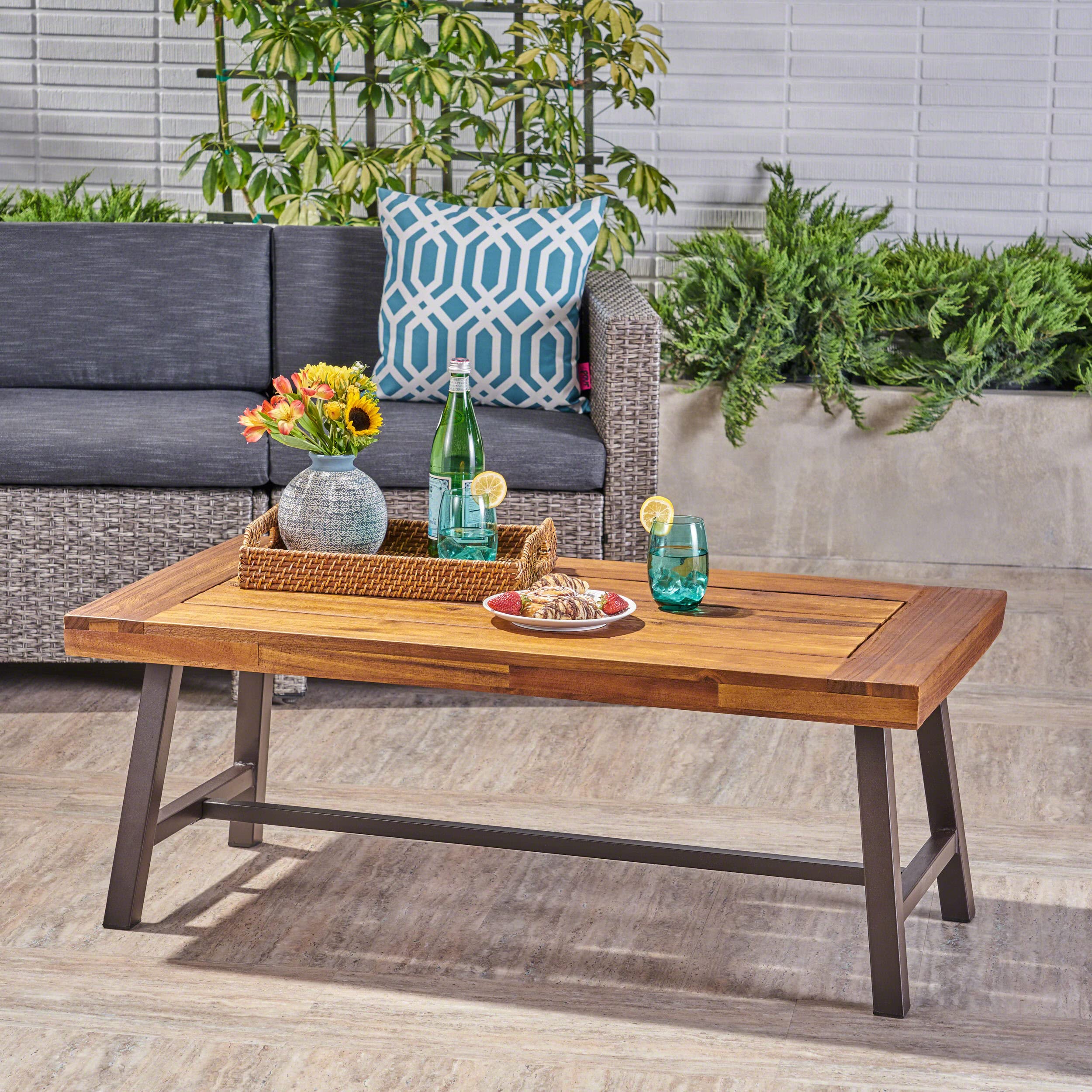 Carlisle powder-coated frame complements weather-ready acacia wood for patio setups.