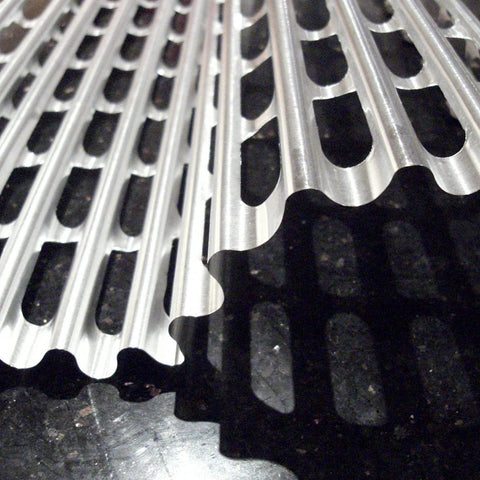 Clean BBQ liners on a hot grill for easy food release