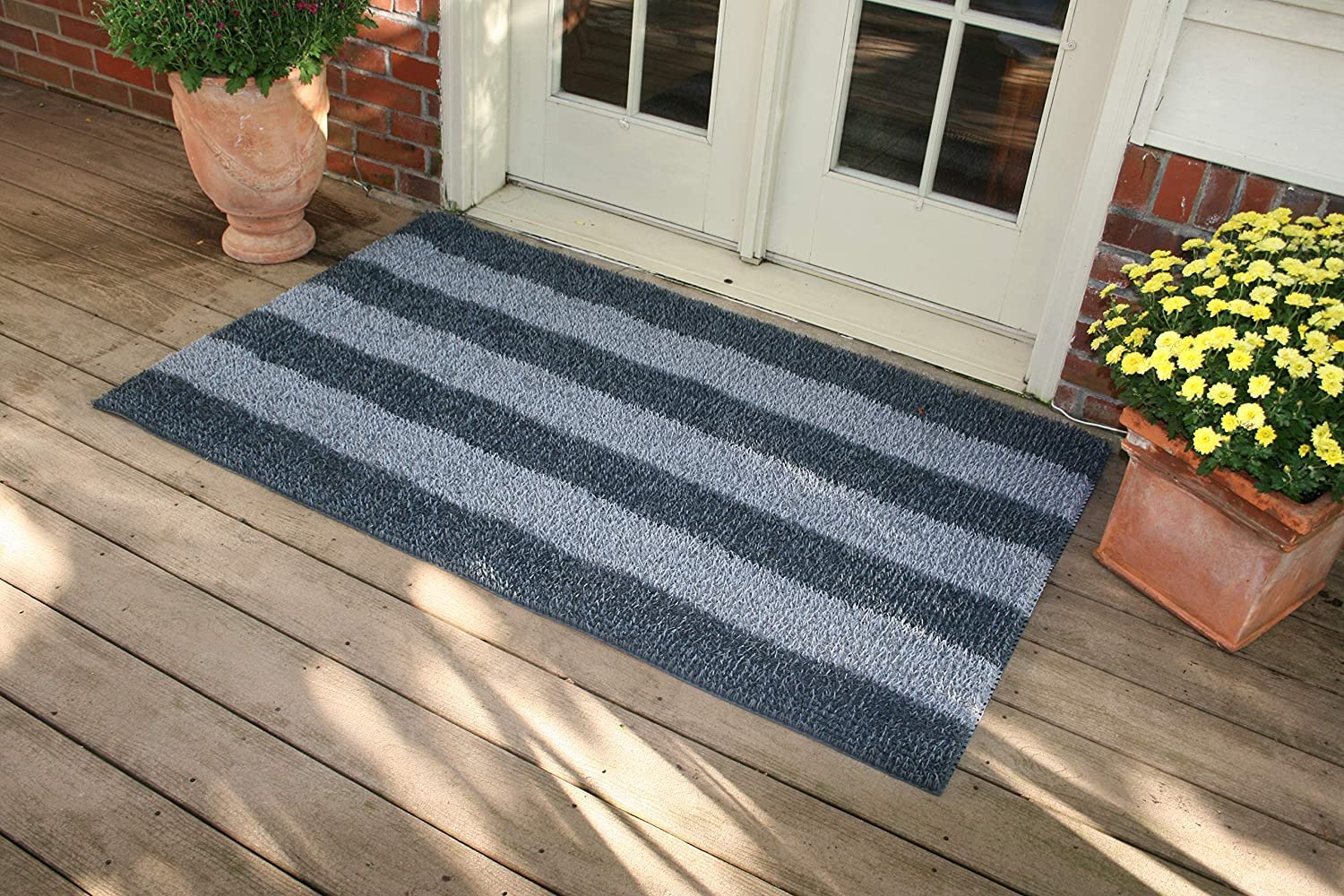 Clean Machine Dirt Trapper Doormat for outdoor entry, showing outdoor placement and dirt scraping