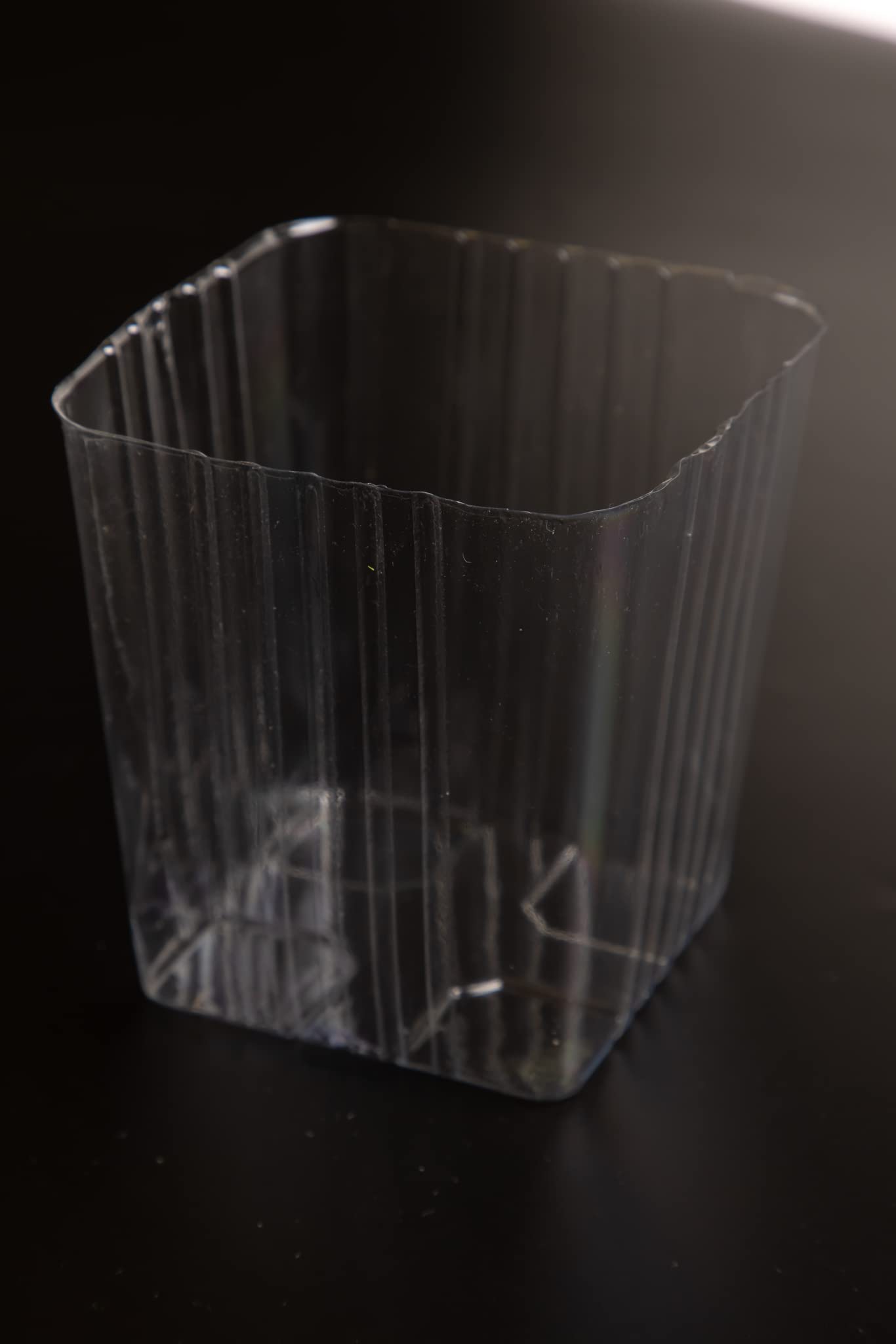 Pack of 12 Clear Plastic Liners shown with planters for mess control.