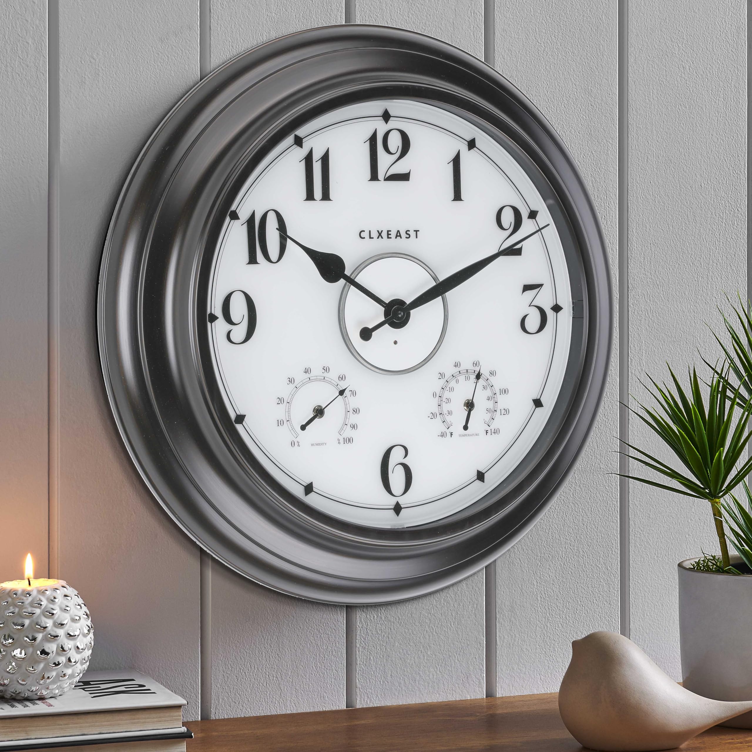 CLXEAST outdoor clock illuminated at night for easy viewing