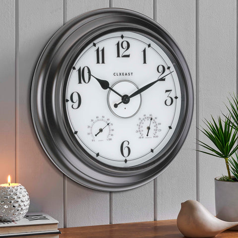 CLXEAST outdoor clock illuminated at night for easy viewing