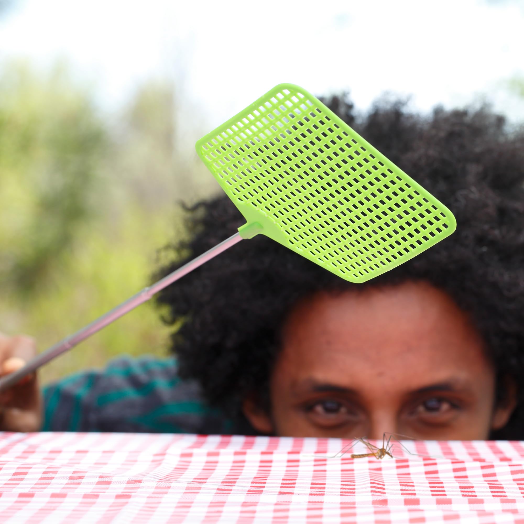 Coghlan's fly swatter leather-strap storage keeps it handy between meals