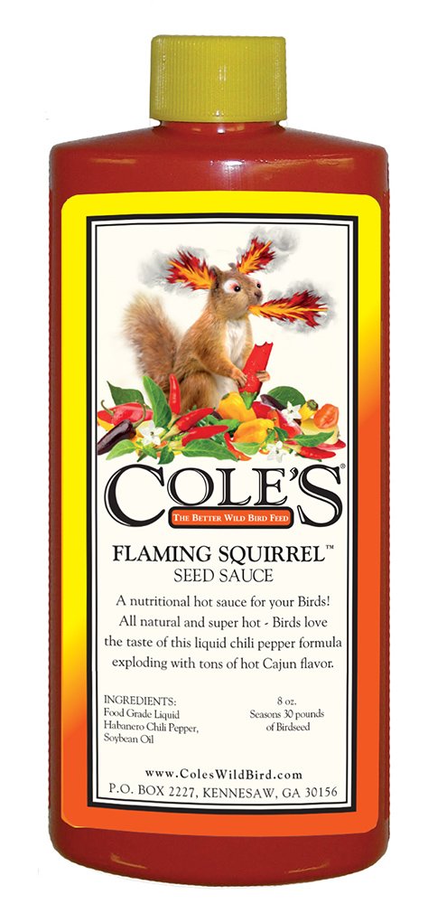 Cole's Flaming Squirrel Seed Sauce bottle poured to attract backyard birds
