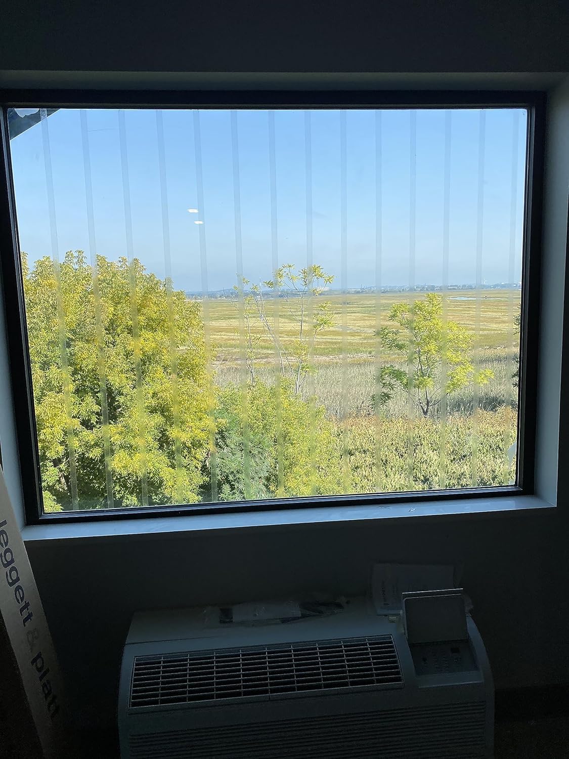 Perforated vinyl film from CollidEscape Spiderweb Clear BirdTape minimizes reflections on glass.