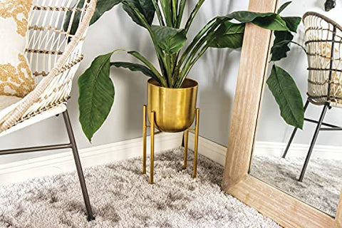 CosmoLiving gold dome planter arranged on a console with decorative items