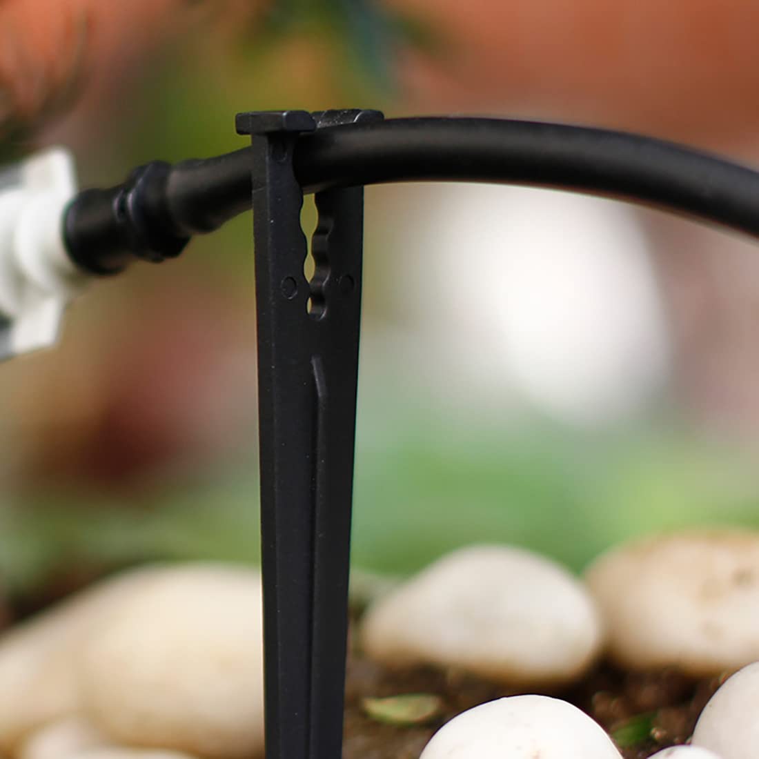 cozyou holds 1/4 inch tubing in place beside plants for efficient watering