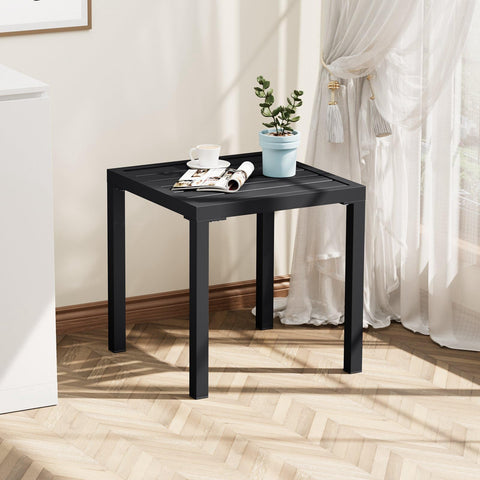 Crestlive table beside lounge chairs holds cups and small essentials.