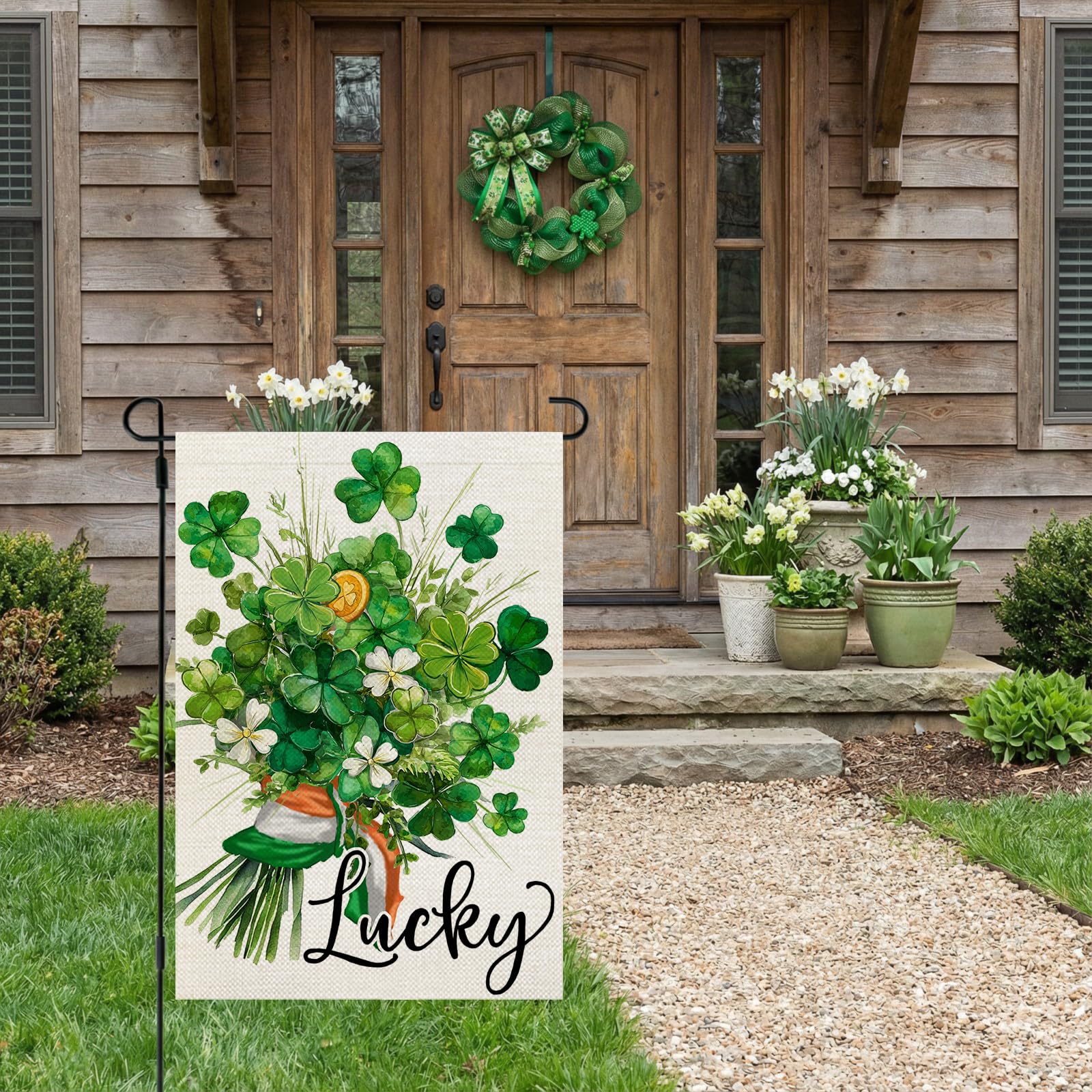 CROWNED BEAUTY shamrocks and floral design on a garden flag for festive curb appeal.