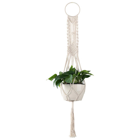 Cuttte cream macrame plant hanger with four legs displaying a pot.