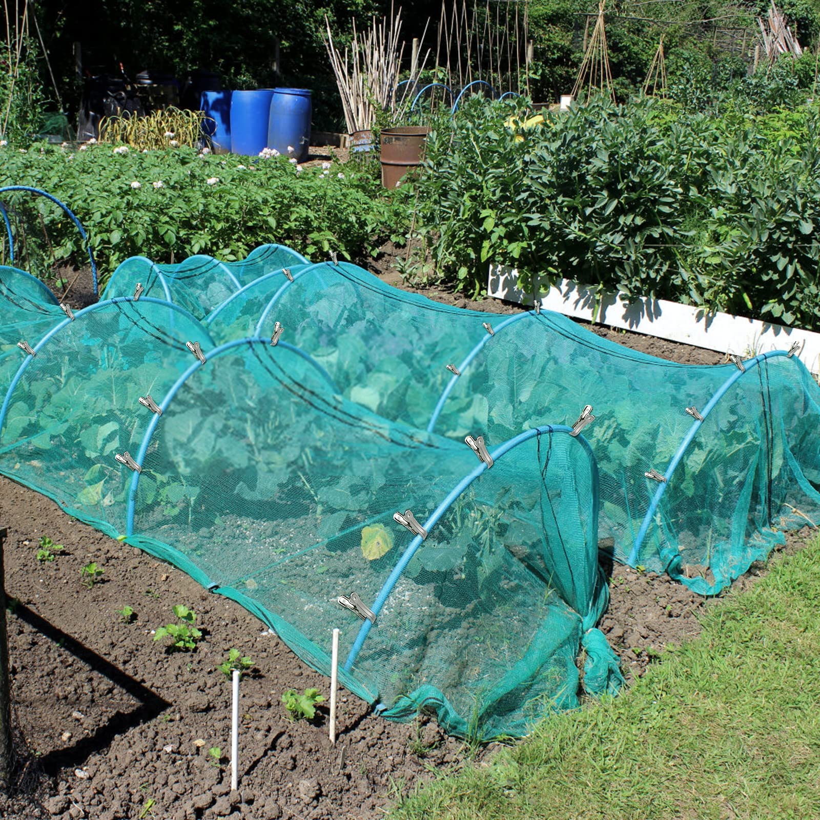 Cuxeedi shade cloth secured by a clip on a greenhouse hoop