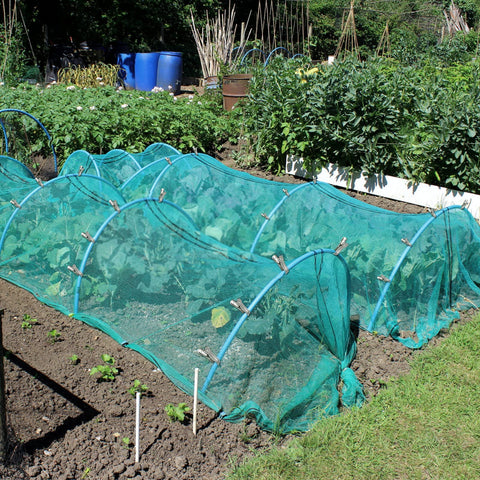 Cuxeedi shade cloth secured by a clip on a greenhouse hoop
