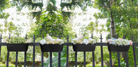 Dahey countryside-style metal planters brighten walls and entryways.