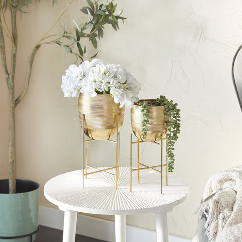Close-up of Deco 79 gold planter with removable stand for versatile display.