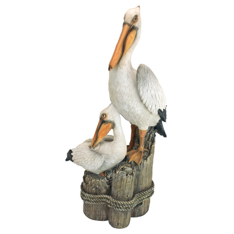 Design Toscano oceanside pelicans perch statue on a pedestal for coastal yard appeal.