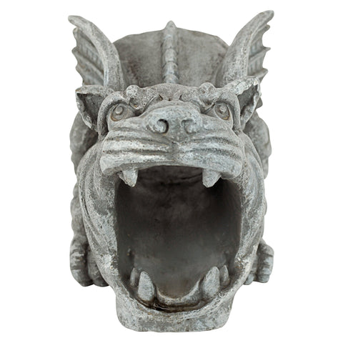 Design Toscano Roland gargoyle garden statue doubles as a rain-blocking feature.
