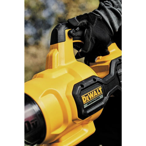 DEWALT 60V MAX FlexVolt leaf blower moving leaves with 600 CFM airflow.