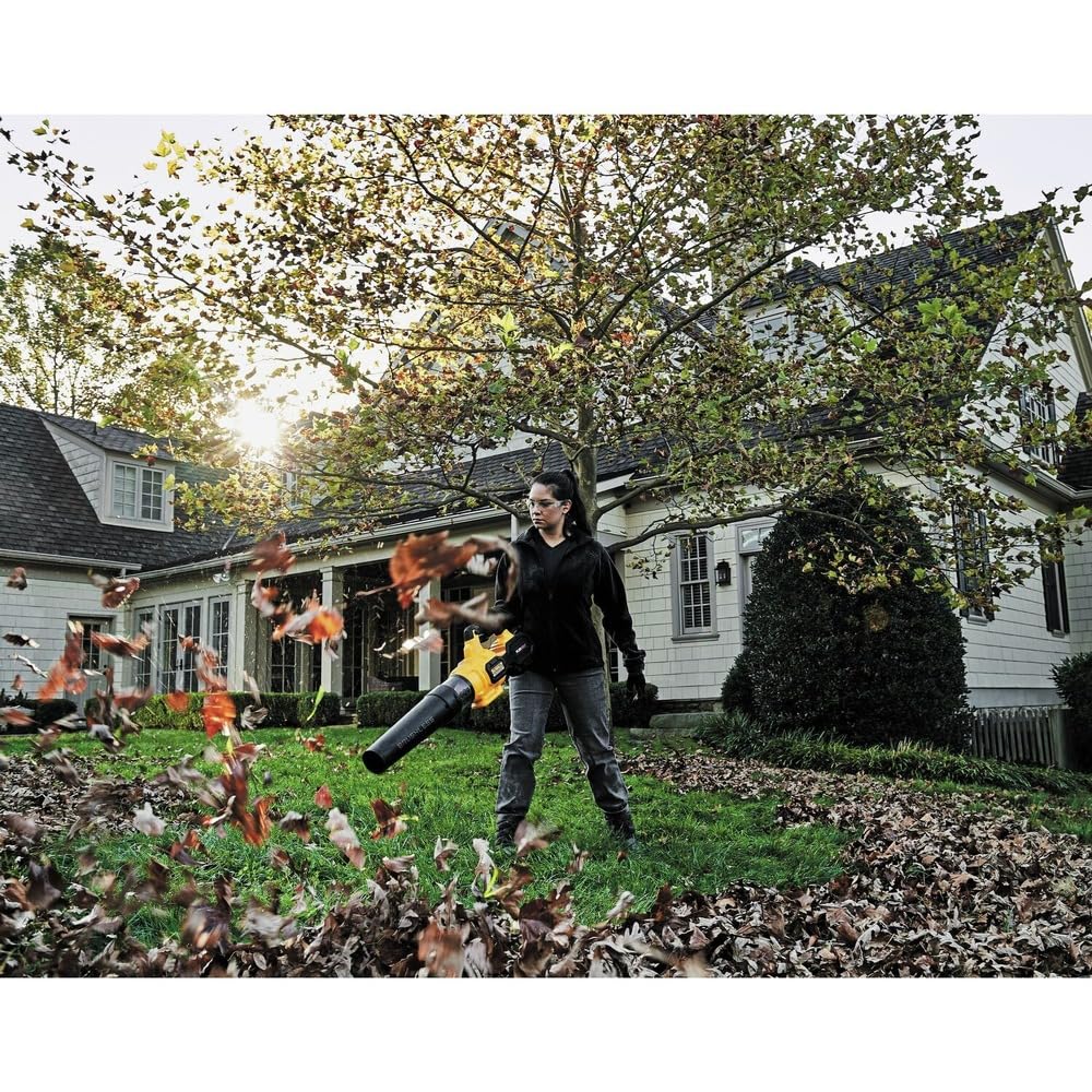 DEWALT cordless leaf blower in use on a patio for outdoor cleanup.