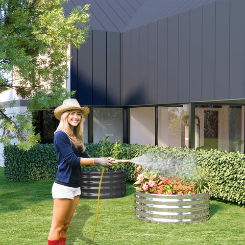 DIIYIV outdoor garden with herbs thriving in galvanized raised beds.