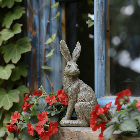 DiliComing patio bunny statue in gray complements stone or wood textures.