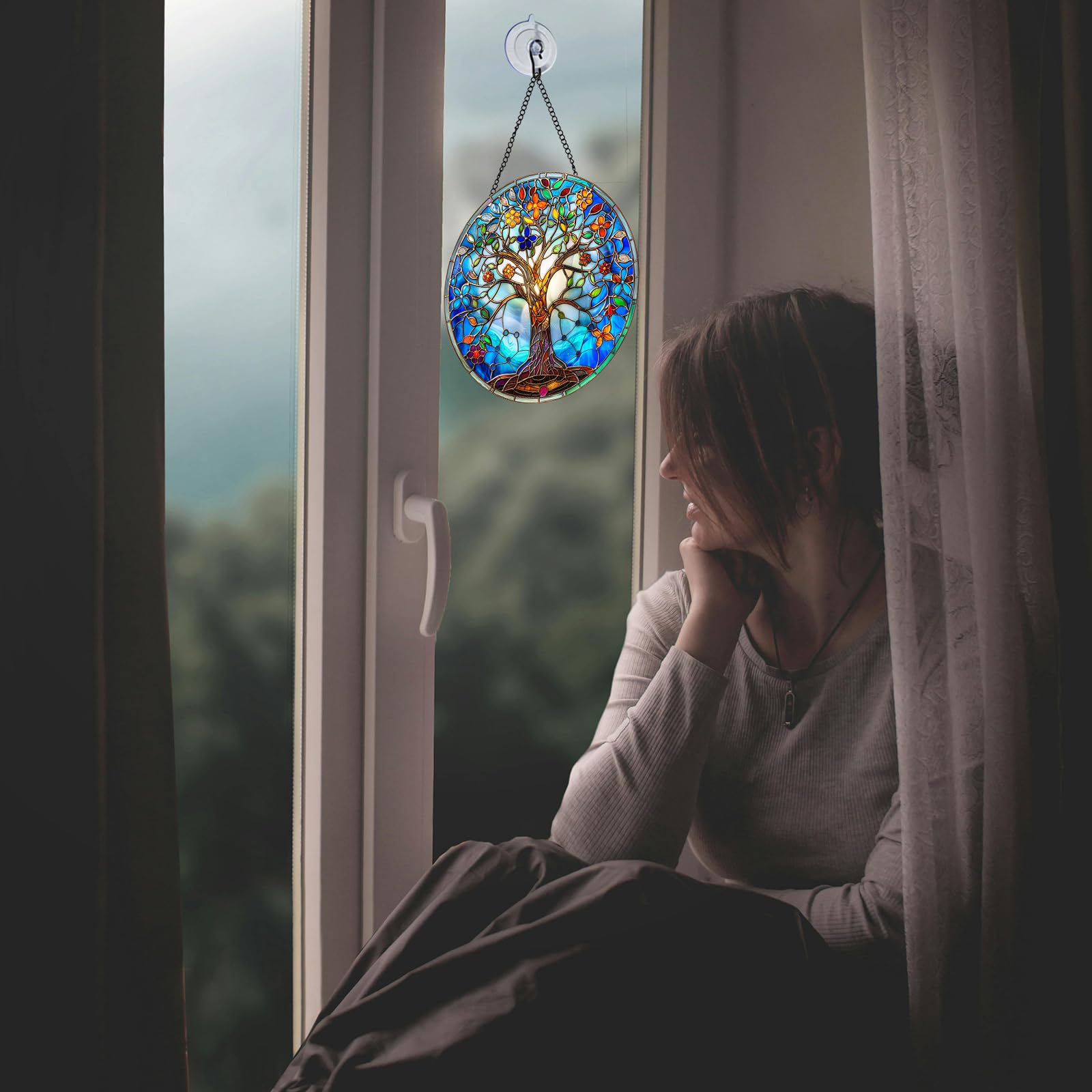 DLNNBKB Tree of Life Suncatcher decorates patio or balcony spaces with color.