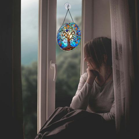 DLNNBKB Tree of Life Suncatcher decorates patio or balcony spaces with color.