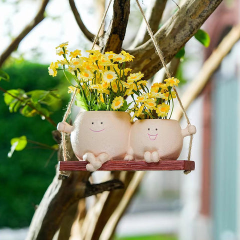 Dolkgy swinging face planter adds whimsical indoor plant decor.