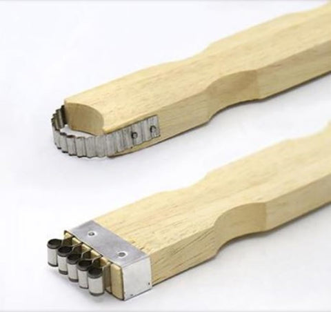 Dolphin Shop coconut grater handle closeup highlighting smooth wooden grip