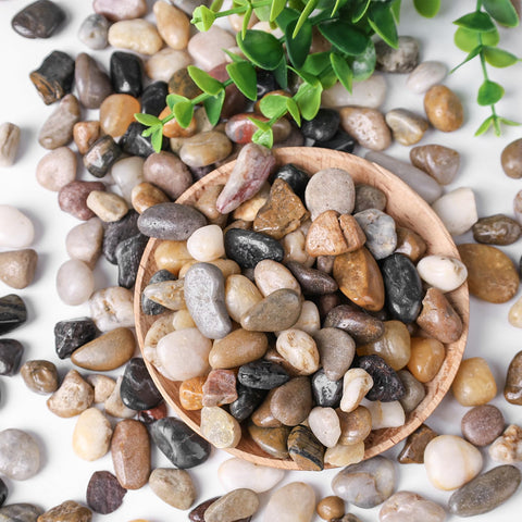 Round smooth pebbles in a garden bed providing drainage and style