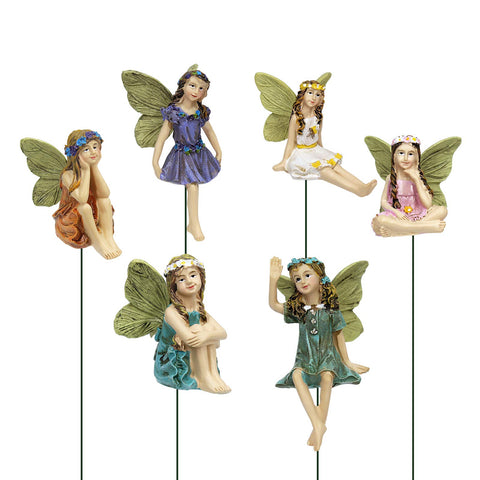 Dorlotou fairy garden figurines in a sunny yard enhance outdoor decor.