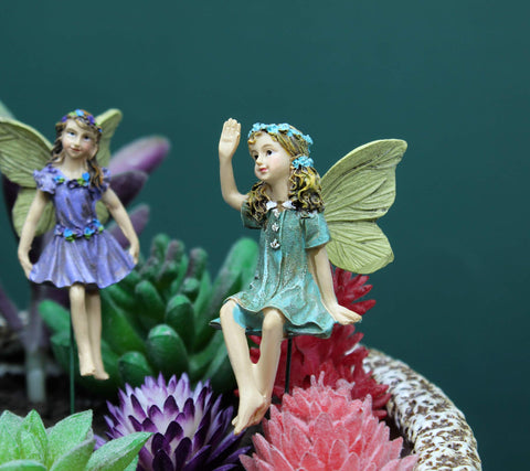 Dorlotou garden fairies on a patio centerpiece for visual charm.