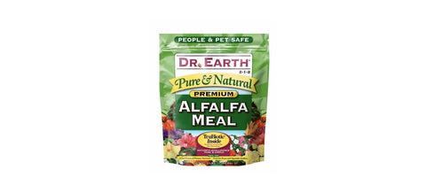 Dr. Earth Alfalfa Meal Plant Food applied in garden for robust root development.