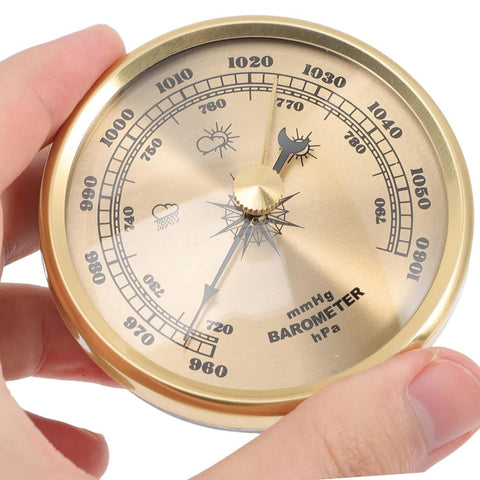 Dranvosk gold barometer in hand shows portable, pocket-friendly design.