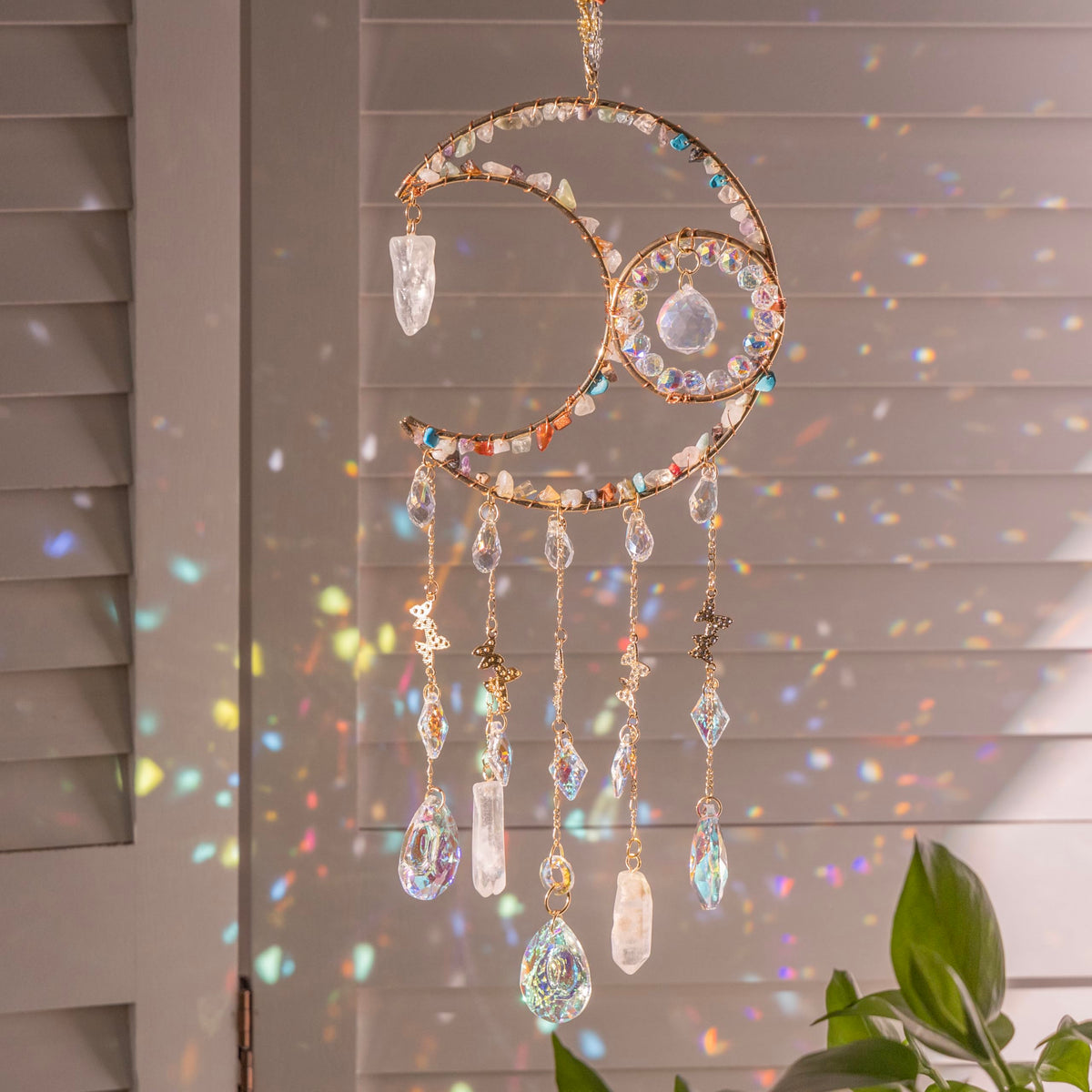 Dreamsum sun catcher rainbow over moon centerpiece casting colorful light through windows.