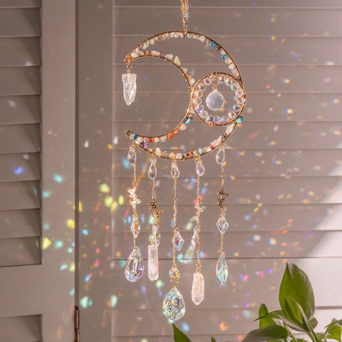 Dreamsum sun catcher rainbow over moon centerpiece casting colorful light through windows.