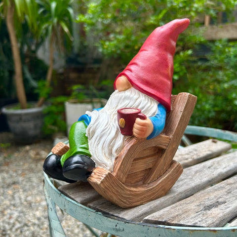 Drinking Coffee Gnome statue on patio boosts cozy outdoor ambience.