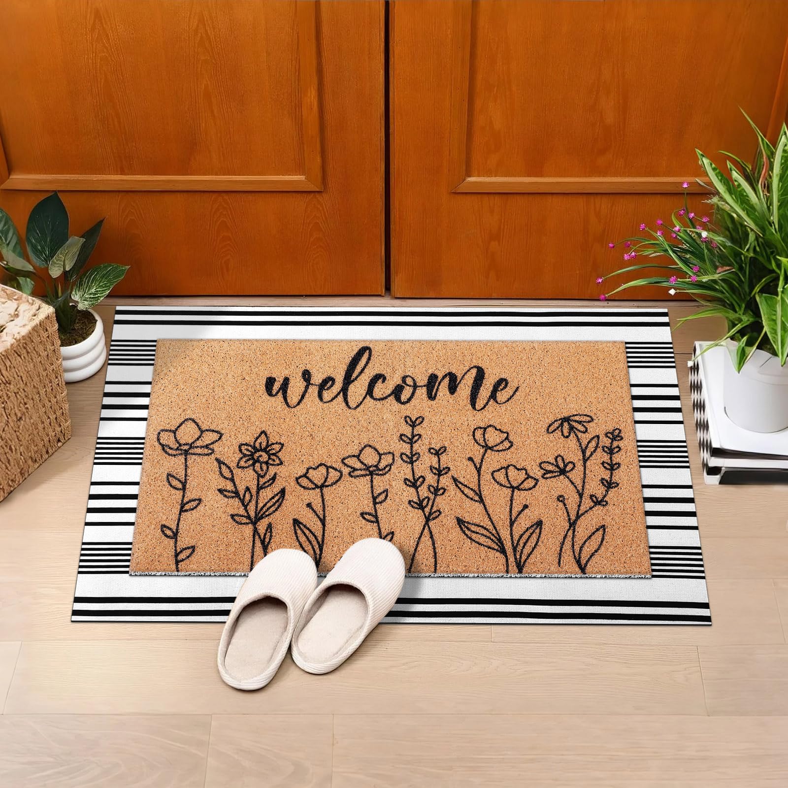 Drydiet black-and-white striped wildflower rug highlights a rustic entrance.