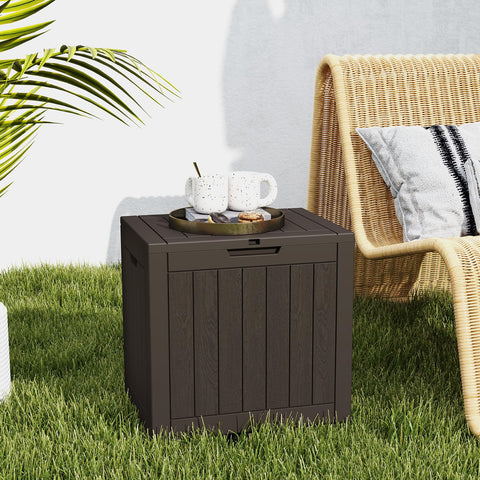 DUMOS deck box storing cushions and pool supplies outdoors.