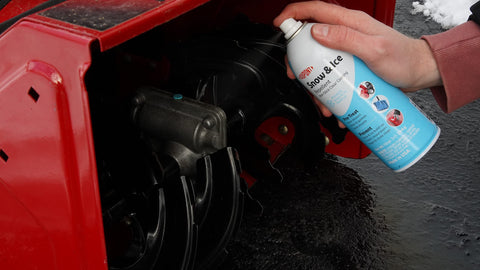 DuPont Teflon spray bottle applying repellant to a shovel for snow prevention.