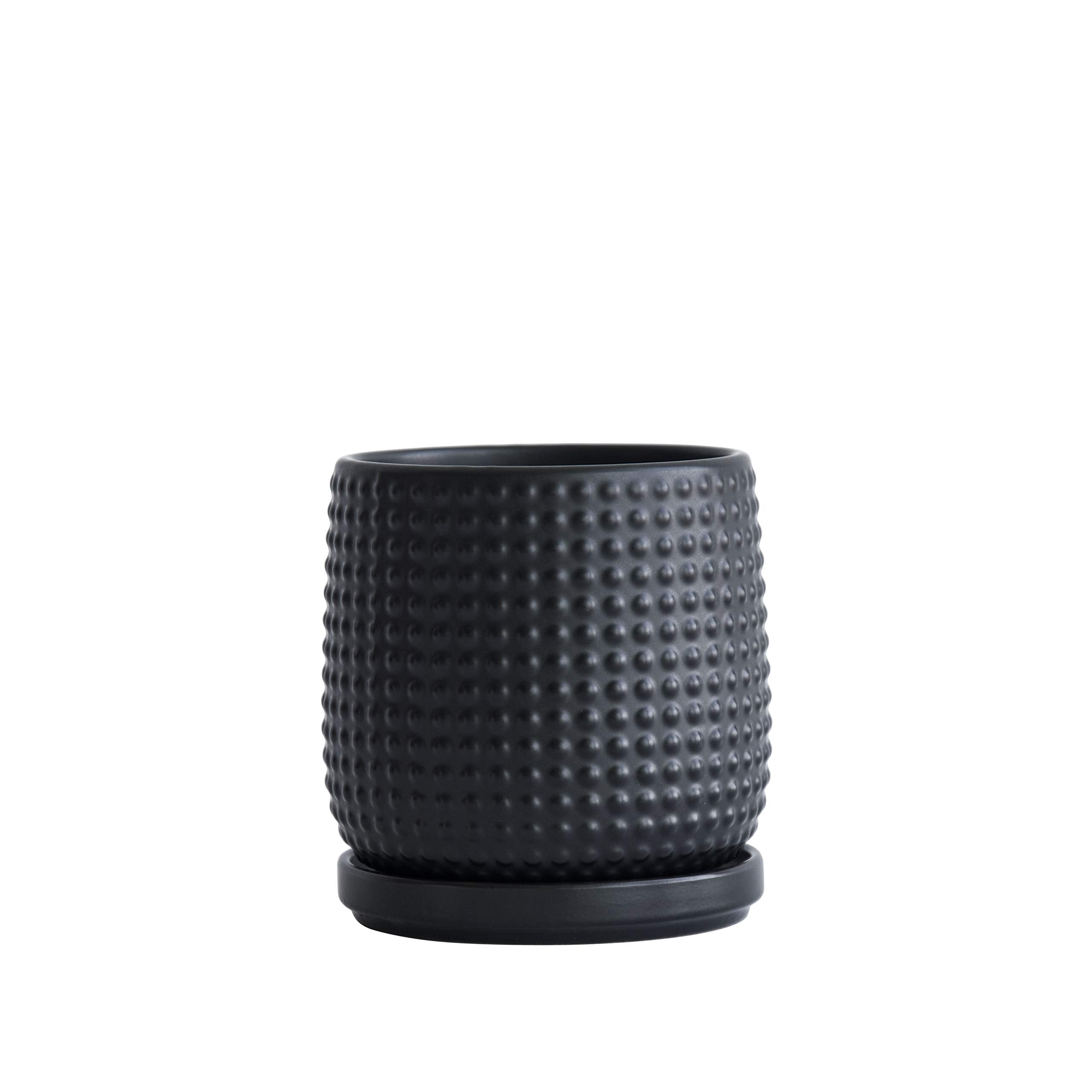 D'vine Dev Ebony Matte planter on a window sill with a lush indoor plant.